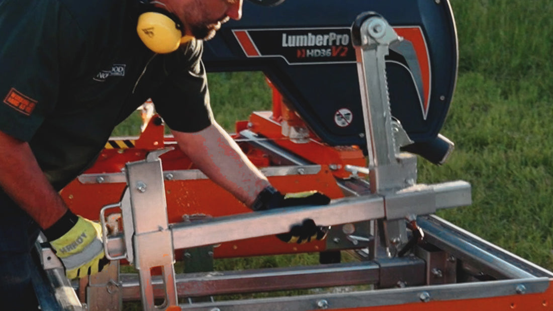Laterally movable log clamping stations